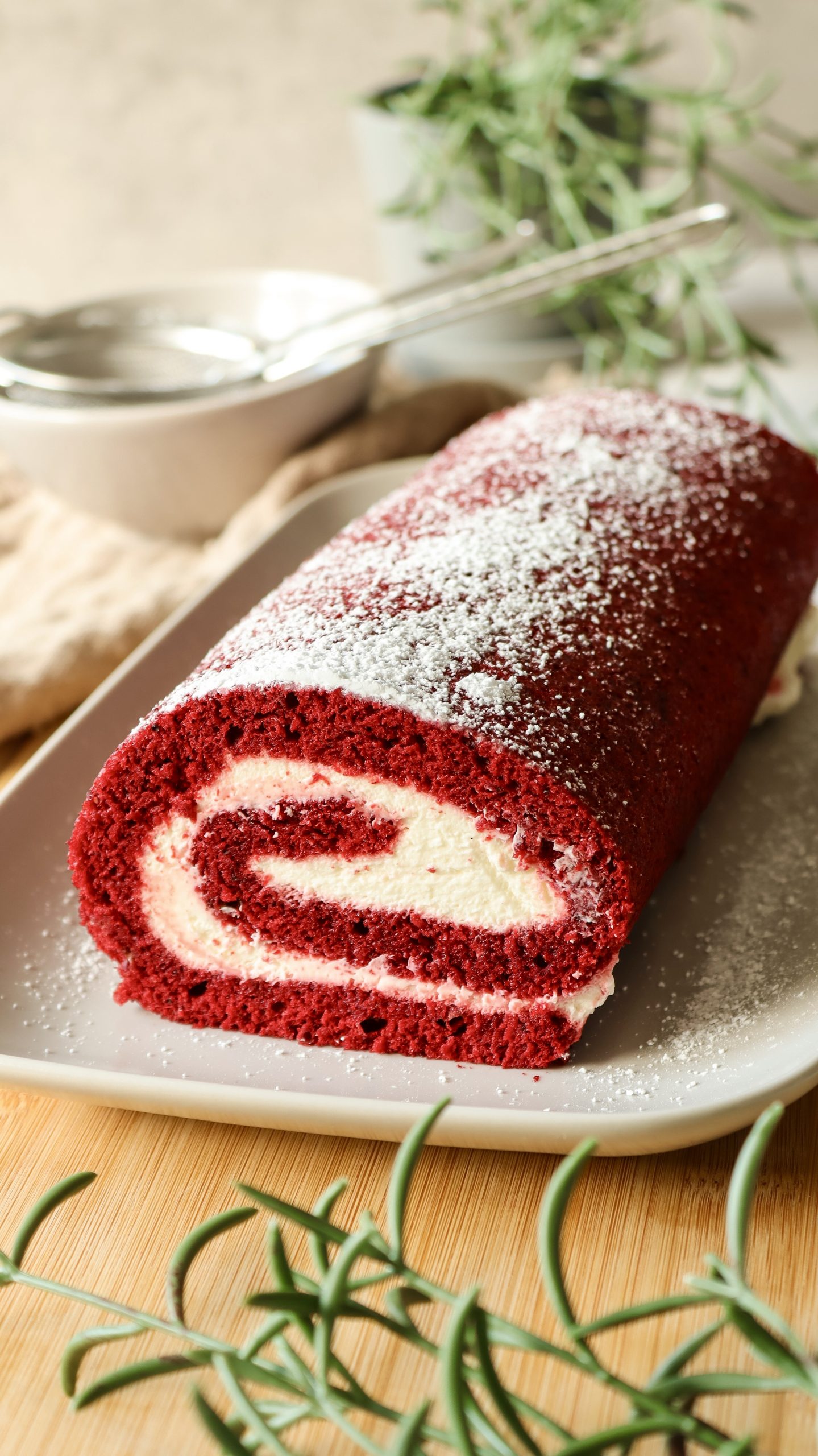 Red Velvet Biskuitrolle mit heller Cremef&uuml;llung, sauber aufgerollt und dekorativ angerichtet